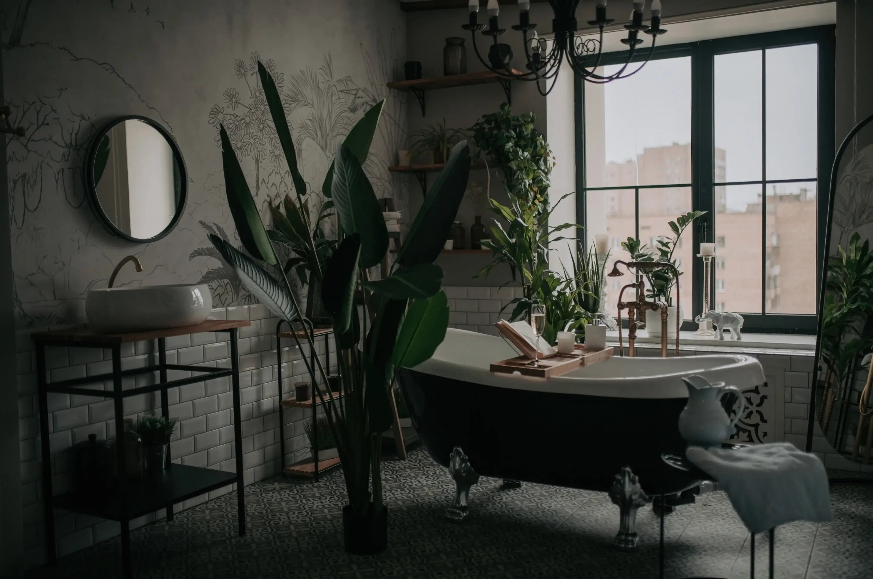 Stylish modern bathroom with a freestanding bathtub, multiple tropical houseplants, and a north-facing window; low natural light conditions.